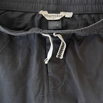 Close-up of striped leg design on boys charcoal pants