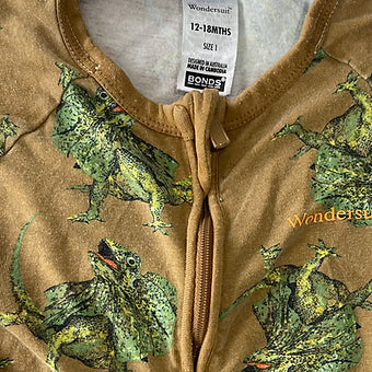 Close-up of fabric and dinosaur pattern on Bonds baby onesie
