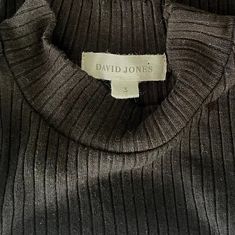 Close-up detail of fabric texture and turtleneck collar