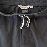Close-up of striped leg design on boys charcoal pants