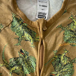 Close-up of fabric and dinosaur pattern on Bonds baby onesie