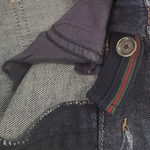Close-up of Gucci logo tag on kids’ denim jeans