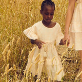  Beautiful girls' smock dress with oversized ruffled sleeves, white crochet trim, and a relaxed fit, made from 100% cotton | Dream Nu